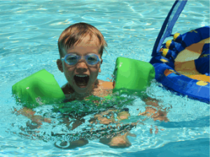 A toddler swimming in a pool. Traditional Bug Sprays and Chlorine: A Dangerous Combination